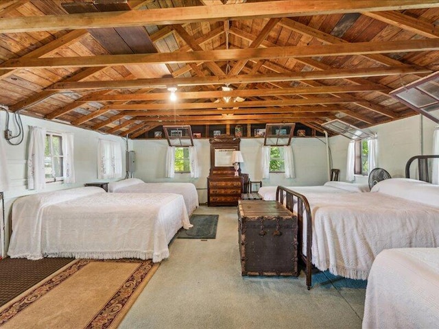 carpeted bedroom with vaulted ceiling and wood ceiling