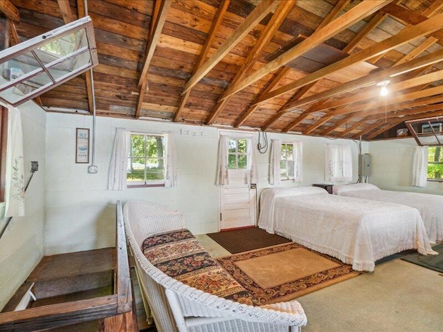 bedroom with lofted ceiling with beams and wood ceiling