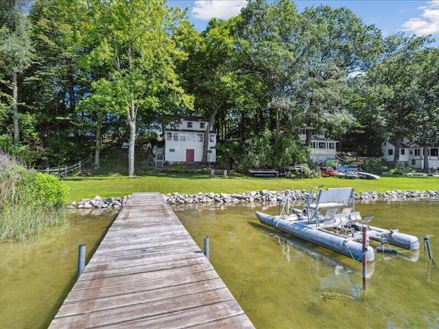 dock area featuring a water view and a yard