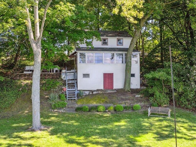 view of outbuilding with a lawn