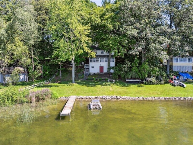 dock area featuring a yard and a water view