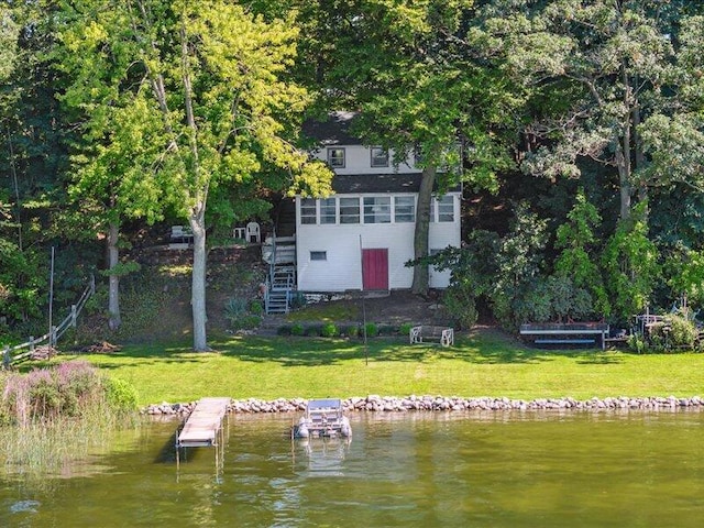 dock area featuring a water view and a lawn