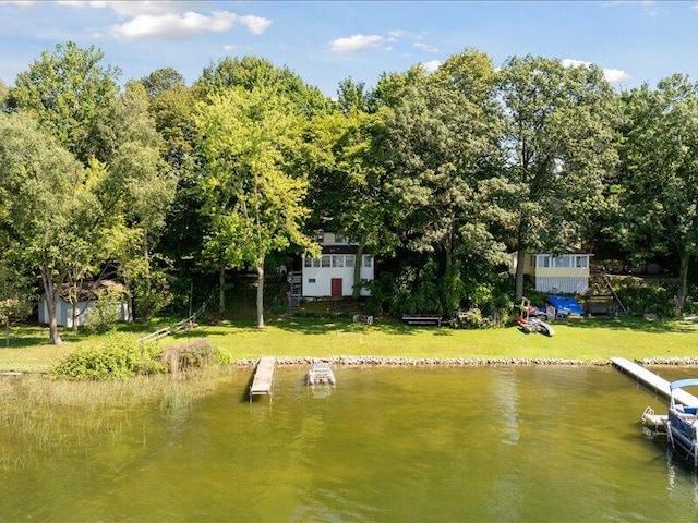 dock area with a water view and a yard