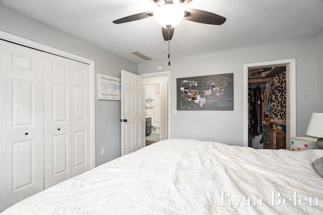 bedroom with ceiling fan, a spacious closet, and a closet