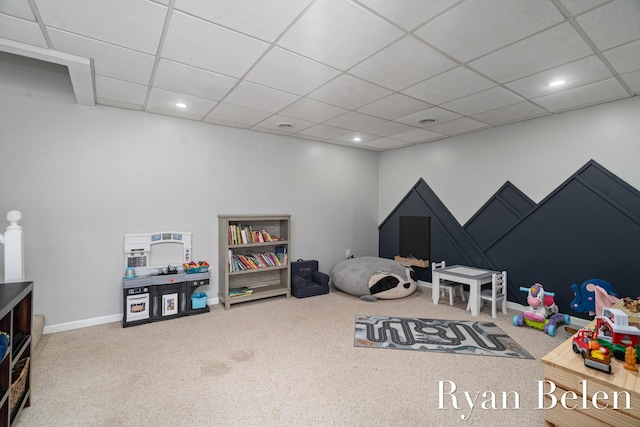 rec room featuring a drop ceiling and carpet flooring