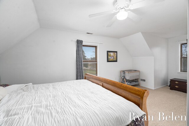 bedroom featuring vaulted ceiling, light carpet, and ceiling fan