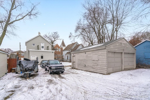 exterior space featuring a garage and an outdoor structure