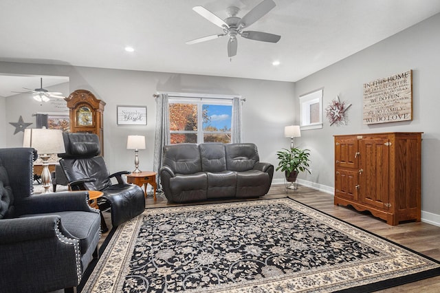 living room with wood-type flooring and ceiling fan