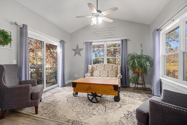 living area with vaulted ceiling, ceiling fan, and light wood-type flooring