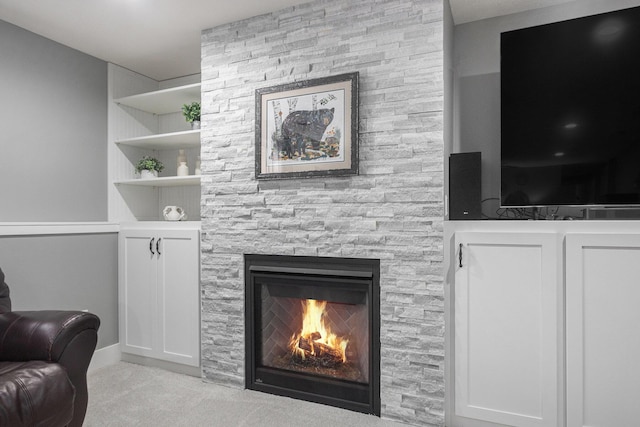 living room featuring a fireplace and built in features