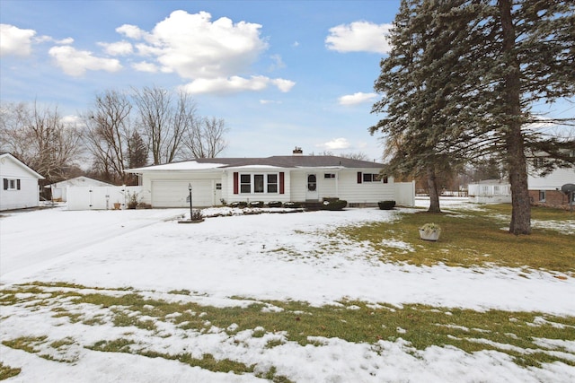 snow covered property with a garage