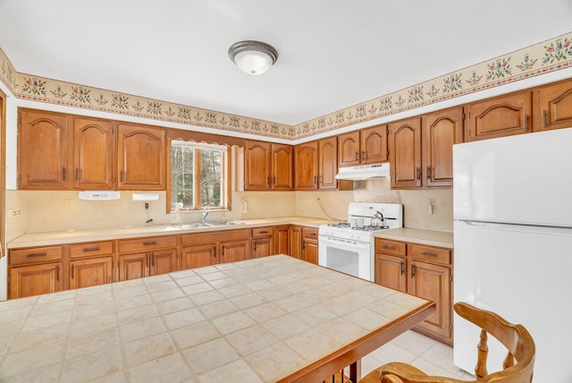 kitchen featuring white appliances, sink, and light tile patterned floors