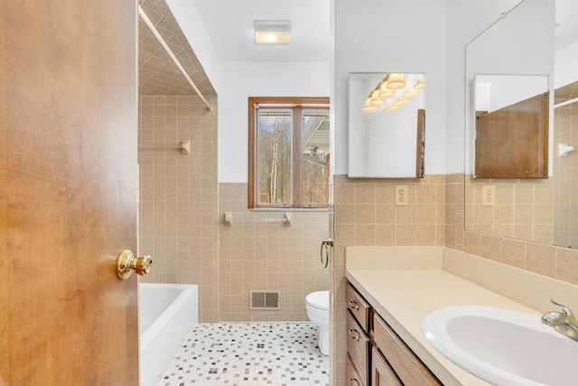 full bathroom featuring vanity, toilet, independent shower and bath, and tile walls