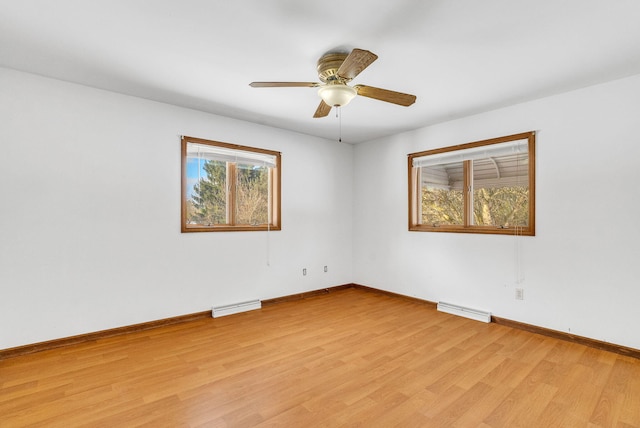 unfurnished room featuring plenty of natural light, ceiling fan, and light wood-type flooring