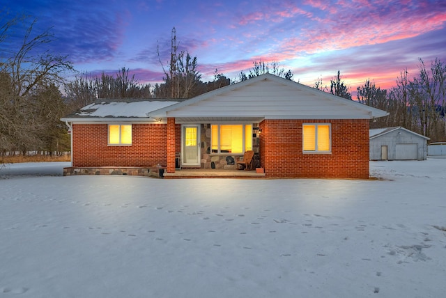 back house at dusk featuring a garage, an outdoor structure, and a porch