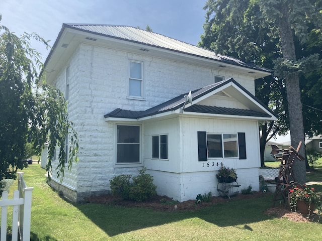 view of property exterior featuring a lawn