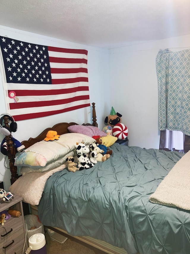 bedroom featuring carpet floors and a textured ceiling