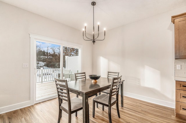 dining room with an inviting chandelier and light wood-type flooring