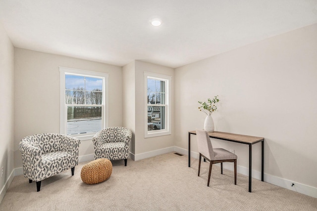 sitting room with light colored carpet