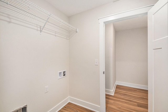 clothes washing area with hookup for a washing machine and hardwood / wood-style flooring