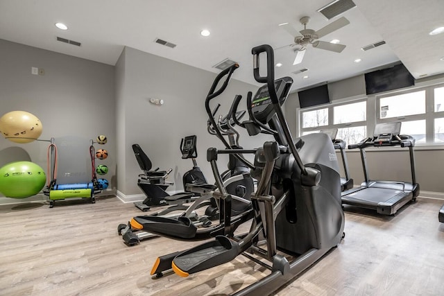 gym with ceiling fan and light hardwood / wood-style floors