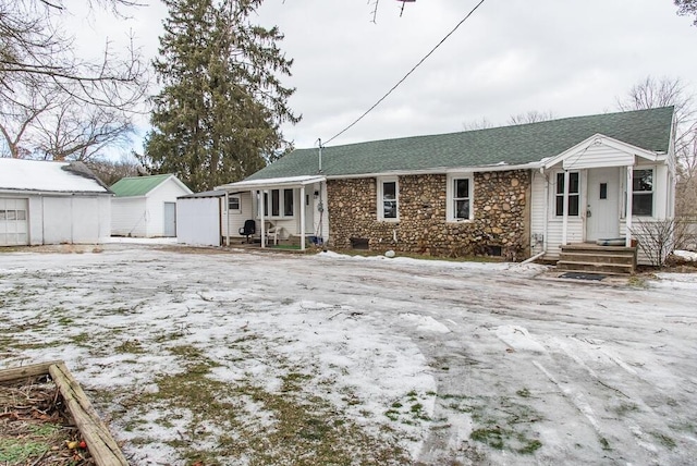 view of front of house with a storage shed