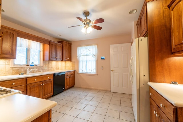 kitchen featuring light tile patterned flooring, dishwasher, sink, decorative backsplash, and white fridge