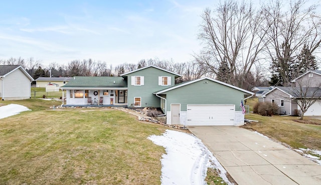 split level home featuring a garage, a front lawn, and covered porch