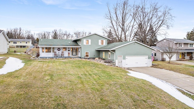 view of front of house featuring a porch, a garage, and a front lawn