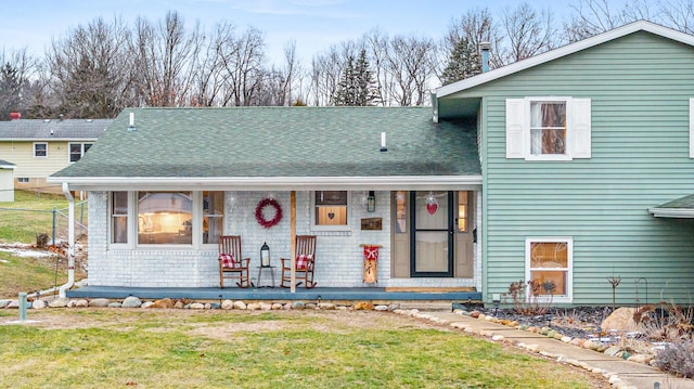 split level home with a front yard and a porch