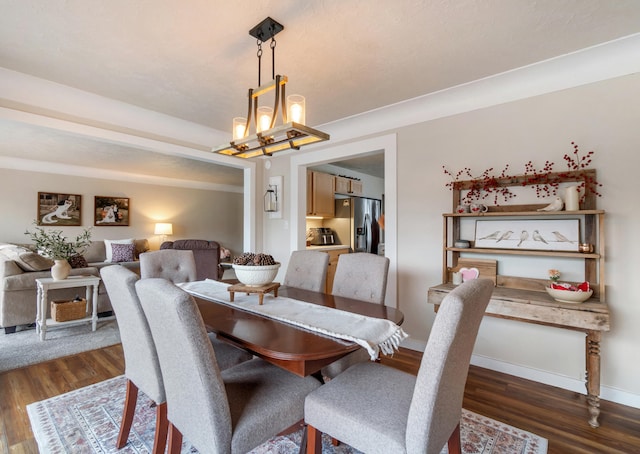 dining area with an inviting chandelier and dark wood-type flooring