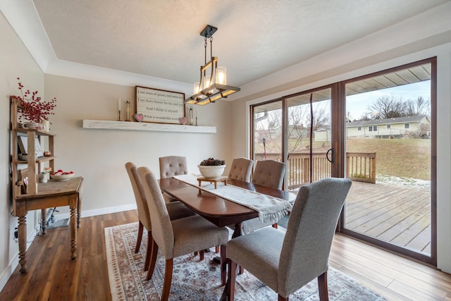 dining area with hardwood / wood-style flooring and a textured ceiling