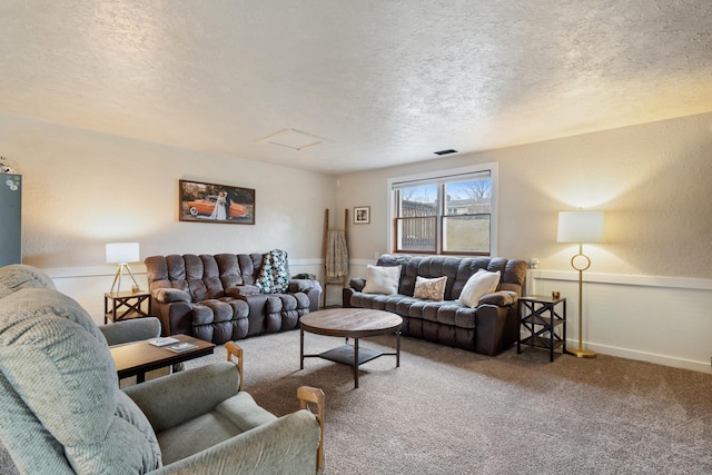 carpeted living room with a textured ceiling