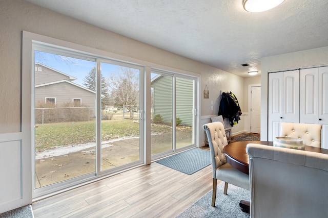 interior space featuring a textured ceiling and light wood-type flooring