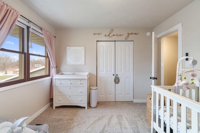 bedroom featuring light colored carpet and a closet