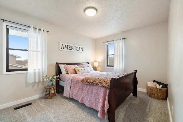 bedroom featuring carpet flooring and a textured ceiling