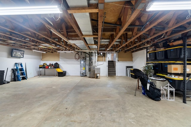 basement featuring heating unit and water heater