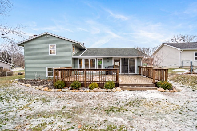 back of property with a wooden deck