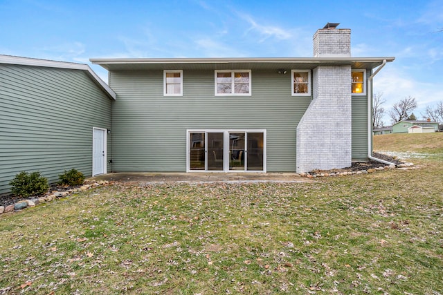 rear view of house featuring a yard