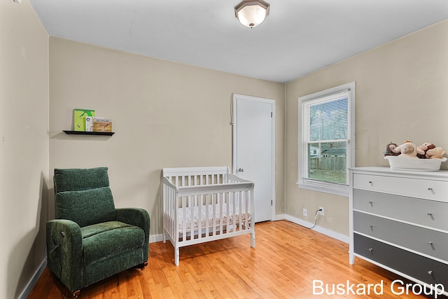 bedroom with baseboards and wood finished floors