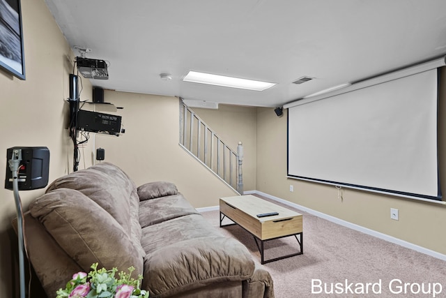 cinema room with carpet floors, visible vents, and baseboards