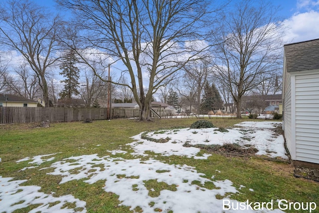 yard layered in snow with fence