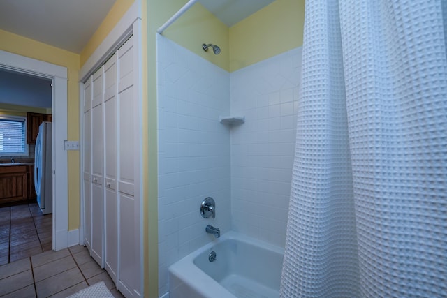 bathroom featuring tile patterned flooring, a closet, and shower / bath combination with curtain