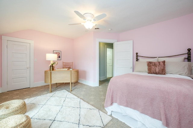 bedroom with light carpet, baseboards, vaulted ceiling, and a ceiling fan