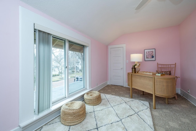 office area with light carpet, vaulted ceiling, baseboards, and ceiling fan