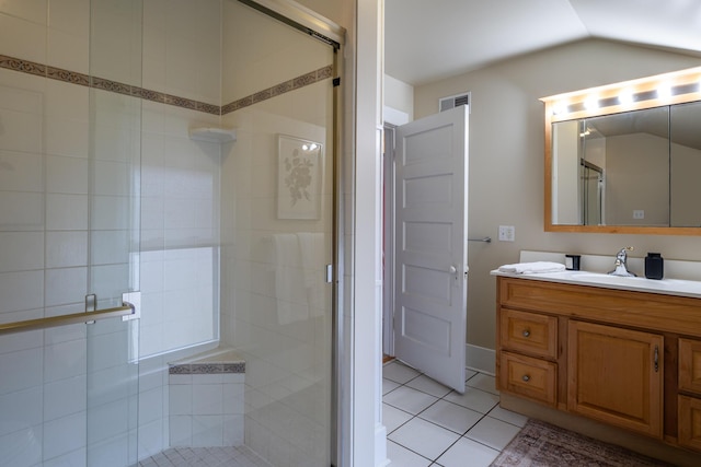 full bath with visible vents, tile patterned flooring, vaulted ceiling, vanity, and a shower stall