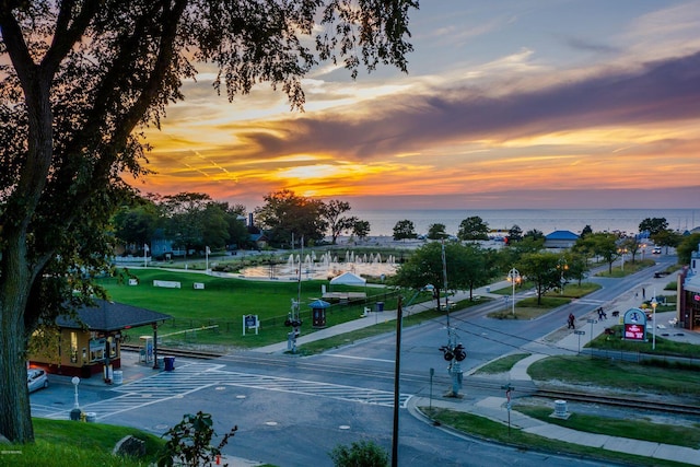 view of street featuring a water view and sidewalks