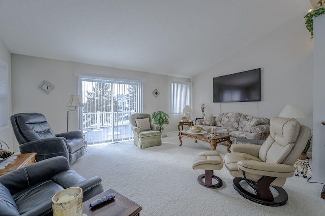 living room featuring lofted ceiling and carpet floors