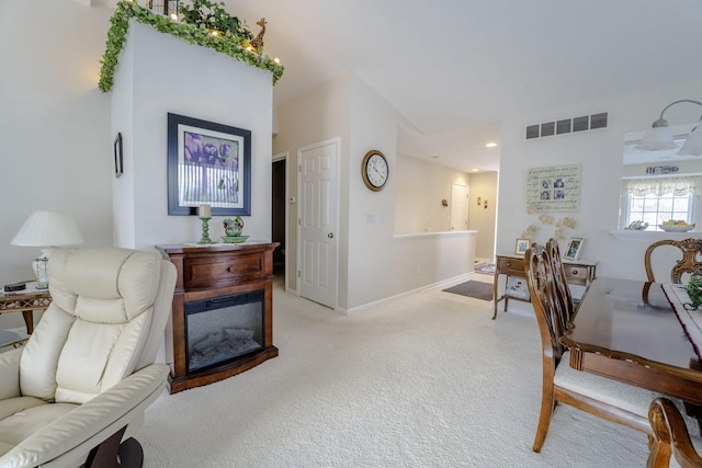 interior space with light colored carpet and a fireplace