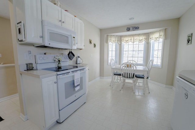 kitchen with white cabinetry and white appliances